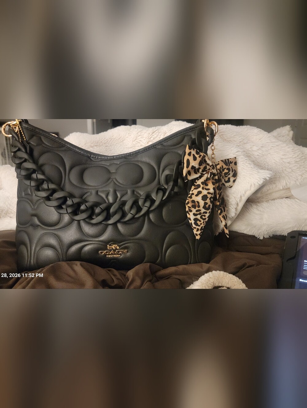 Black Leather Coach Laurel handbag with embossed C logo pattern.
Large size
